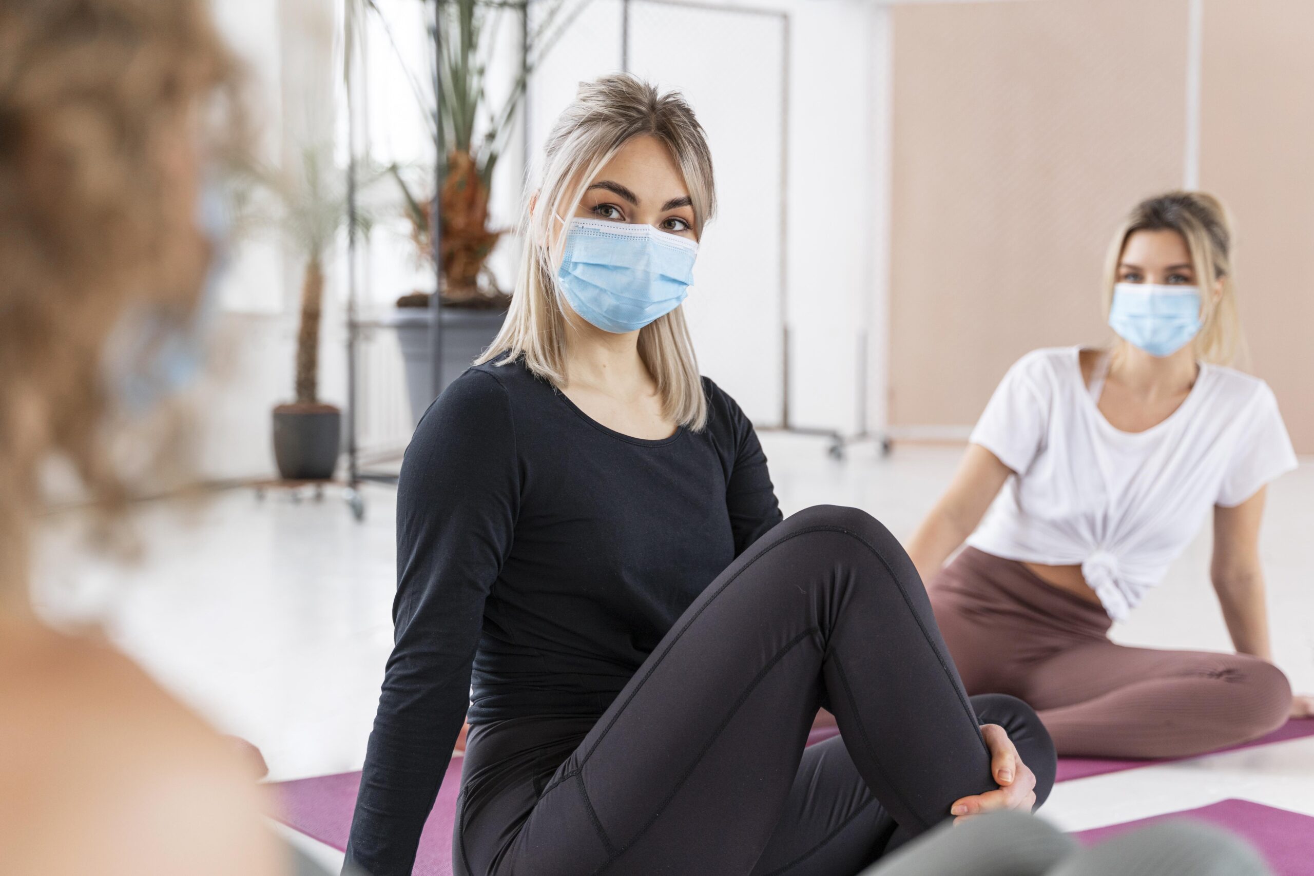 close up women wearing masks