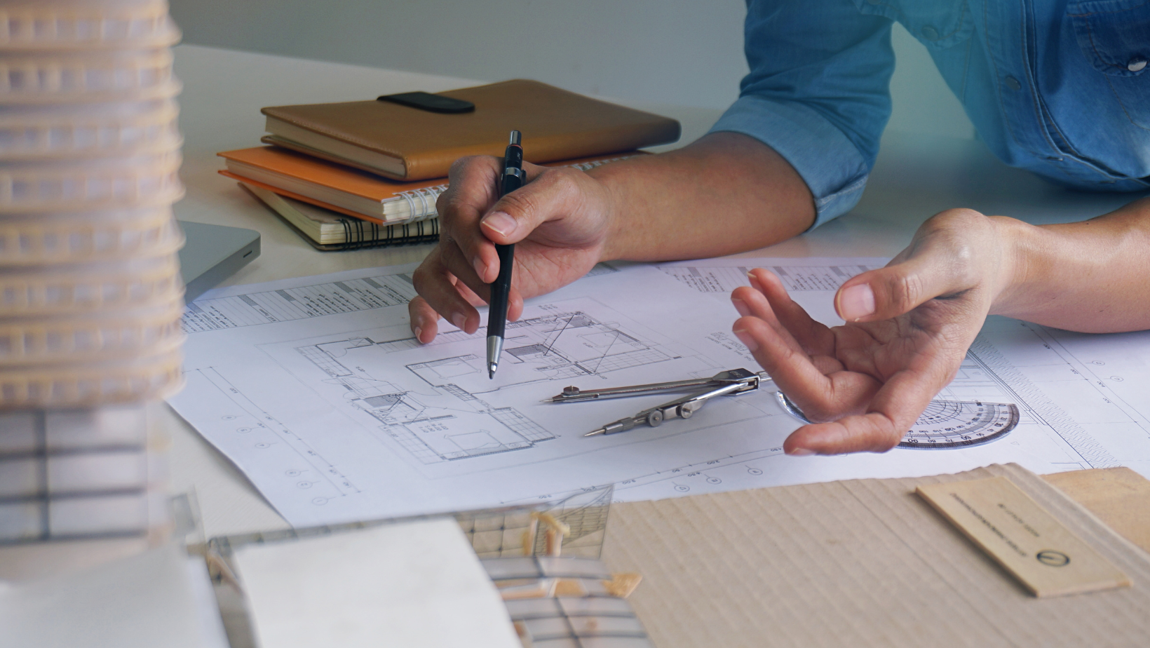 An interior designer reviewing an architectural plan